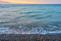 Waves on a pebble beach on a sunset. Royalty Free Stock Photo