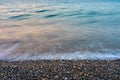 Waves on a pebble beach on a sunset. Royalty Free Stock Photo