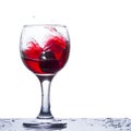 Waves of red wine in a glass on a white background Royalty Free Stock Photo