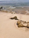 Waves, rock, sand in the beach Royalty Free Stock Photo