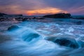 Waves and rocks in the Pacific Ocean at sunset, seen at Shell Be