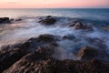 Waves and rocks shore long exposure Royalty Free Stock Photo