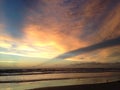 Waves Rolling on Atlantic Ocean Beach during Dawn with Crepuscular Rays. Royalty Free Stock Photo