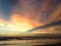 Waves Rolling on Atlantic Ocean Beach during Dawn with Crepuscular Rays. Royalty Free Stock Photo