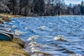 Waves Rolling Onto Shoreline with Boats