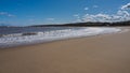 Waves rolling up the smooth sandy beach of the bay, Sea Palling, Norfolk, UK