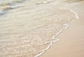 Waves rushing to shore on soft fine sand beach. Royalty Free Stock Photo