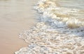 Waves rushing to shore on soft fine sand beach. Royalty Free Stock Photo