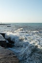 Waves crash on the pier. Sea spray. Beautiful seascape. Royalty Free Stock Photo