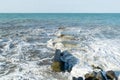 The waves crash on the old pier. The sea is stormy. Royalty Free Stock Photo