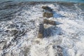 The waves crash on the old pier. seascape. Marine background. Sea spray. Royalty Free Stock Photo