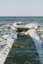The waves crash on the old pier. Royalty Free Stock Photo
