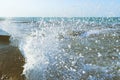 The waves crash on the old pier. Sea spray. Royalty Free Stock Photo