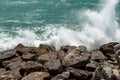 Waves of the sea crash on the rocks - Breakwater in Liguria Italy Royalty Free Stock Photo