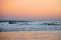 Waves at sea on dramatic sunset background. Waves at sea during storm and wind.