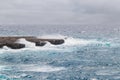 Waves in the sea during a storm. View of big waves in the ocean hitting the rocks with big splashes Royalty Free Stock Photo