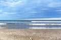 Waves at sea. Waves at sea during storm and wind. Wave from the sea goes on land to the beach.