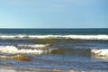 Waves at sea. Waves at sea during storm and wind. Wave from the sea goes on land to the beach.