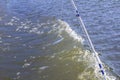 Waves from a small wooden motor boat while searching for a drowned man Royalty Free Stock Photo