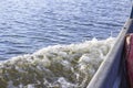 Waves from a small wooden motor boat while searching for a drowned man Royalty Free Stock Photo