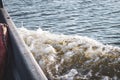 Waves from a small wooden motor boat while searching for a drowned man Royalty Free Stock Photo