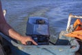 Waves from a small wooden motor boat while searching for a drowned man Royalty Free Stock Photo