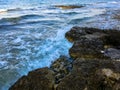 Waves are smash the rocks.