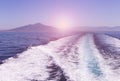 Waves from a speed boat on the water surface in the sea on sunset. Natural and holiday background.