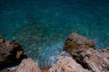 Waves splash against rocks. Marine theme with copy space. Top view natural background of rippled sea-green sea water. Aerial view Royalty Free Stock Photo