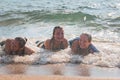 Waves Splash Girls Laying on the Sand Royalty Free Stock Photo