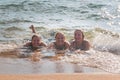 Waves Splash Girls Laying on the Sand Royalty Free Stock Photo