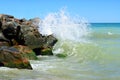 Waves splash on the large boulders on the beach Royalty Free Stock Photo