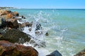 Waves splash on the large boulders on the beach Royalty Free Stock Photo