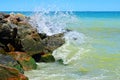 Waves splash on the large boulders on the beach Royalty Free Stock Photo