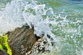 Waves splash on the large boulders on the beach Royalty Free Stock Photo