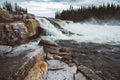 Waves and splashes of mountain river on background of forest, rocks and dramatic sky. Forest river water landscape. Wild river in Royalty Free Stock Photo