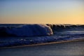 Waves splashes. Sunset over sea with golden dramatic sky panorama. Ocean waves background. Ocean and sky background. Royalty Free Stock Photo