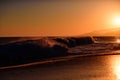 Waves splashes. Sunset over sea with golden dramatic sky panorama. Ocean and sky background. Ocean waves background. Royalty Free Stock Photo