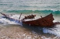 Wreck of stranded fishing boat in waves