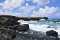 Waves Splashing on to Black Lava Rocks on Aruba Beach Royalty Free Stock Photo