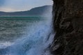 Waves sweeping against the rocks and the beach Royalty Free Stock Photo