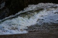 Waves sweeping against the rocks and the beach Royalty Free Stock Photo