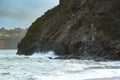 Waves sweeping against the rocks and the beach Royalty Free Stock Photo