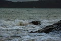 Waves sweeping against the rocks and the beach Royalty Free Stock Photo