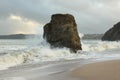 Waves sweeping against the rocks and sand of Carlyon bay in South Cornwall