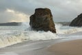 Waves sweeping against the rocks and sand of Carlyon bay in South Cornwall