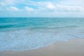 Waves on tropical white beach with blue sky Royalty Free Stock Photo