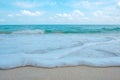 Waves on tropical white beach with blue sky Royalty Free Stock Photo