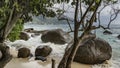 The waves of the turquoise ocean beat against the boulders. Royalty Free Stock Photo