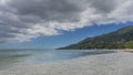 The waves of the turquoise ocean spread over the sandy beach. Royalty Free Stock Photo